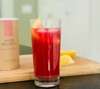 moon balance superfood mix lemonade in glass with lemons on cutting board and mix container-your super superfood reviews-mealfinds