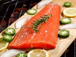 salmon on wood plank on grill