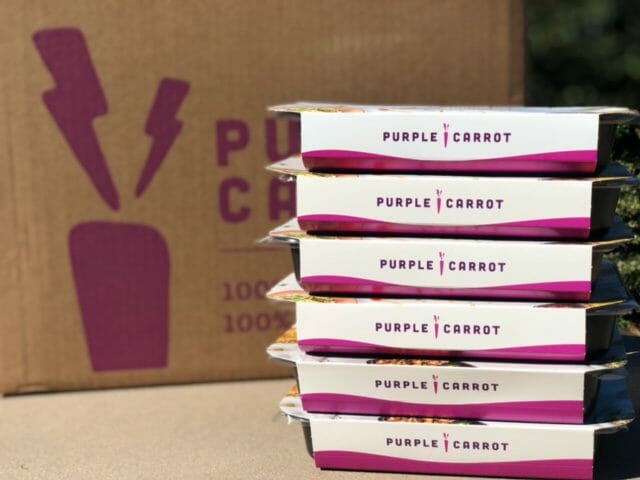 purple carrot prepared meals stacked in front of box-purple carrot vegan meal reviews-mealfinds