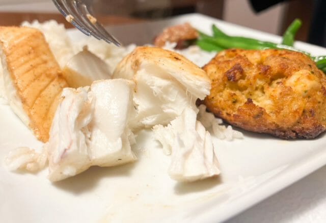 cooked halibut and crabcake on plate-sizzlefish review-mealfinds