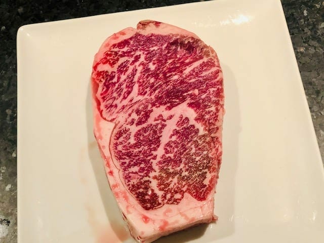 raw american wagyu steak on plate-crowd cow review-mealfinds