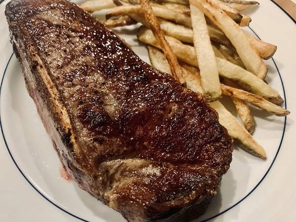 cooked ny strip steak with fries on plate-Meat N Bone reviews-mealfinds