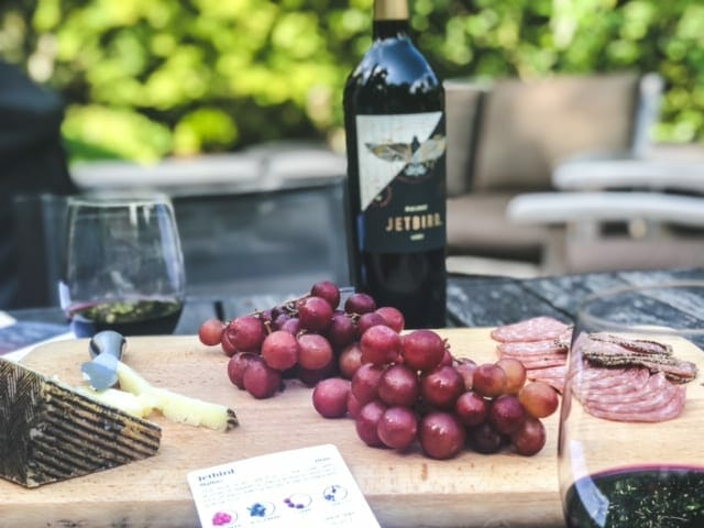 cheese grapes meat board with wine bottle and glasses-bright cellars review-mealfinds