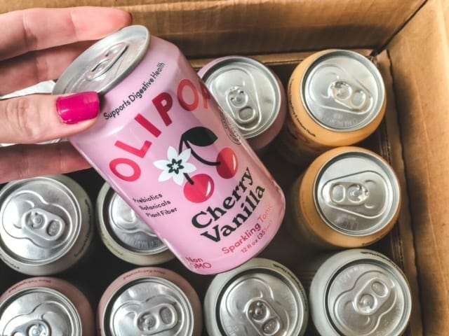 olipop cherry vanilla can coming out of box-olipop soda review-mealfinds