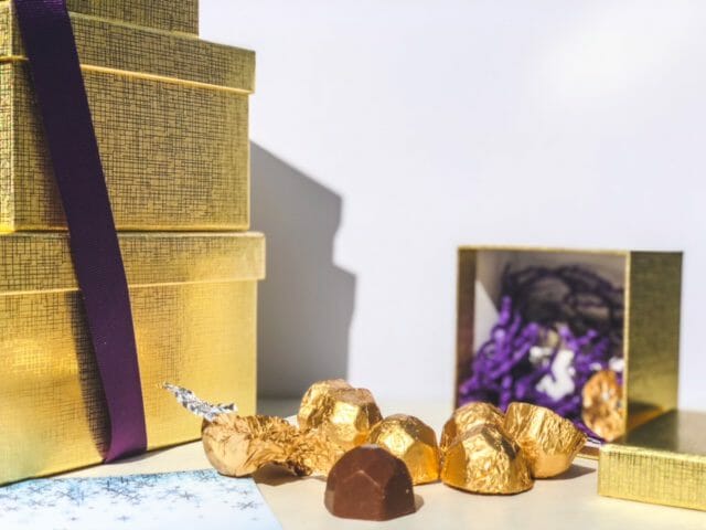 chocolate truffles in gold foil spilling out of gift box-bake me a wish reviews-mealfinds