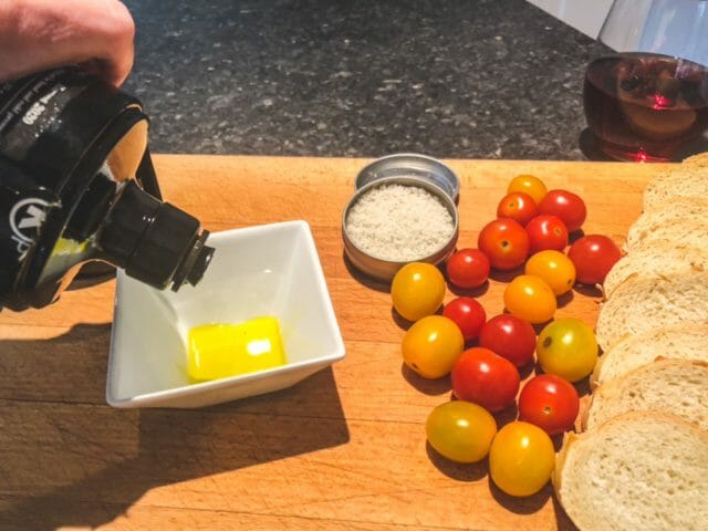 manni olive oil poured into bowl with bread and tomatos-manni best olive oil revews-mealfinds