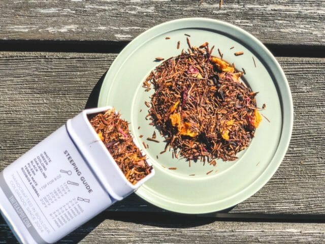 orange tea spilling out on plate-the tea spot reviews-mealfinds