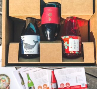 three sake bottles and info cards and guide -tippsy sake reviews-mealfinds