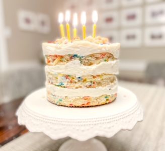 milk bar vanilla birthday cake with lit candles-milk bar birthday cake review-mealfinds