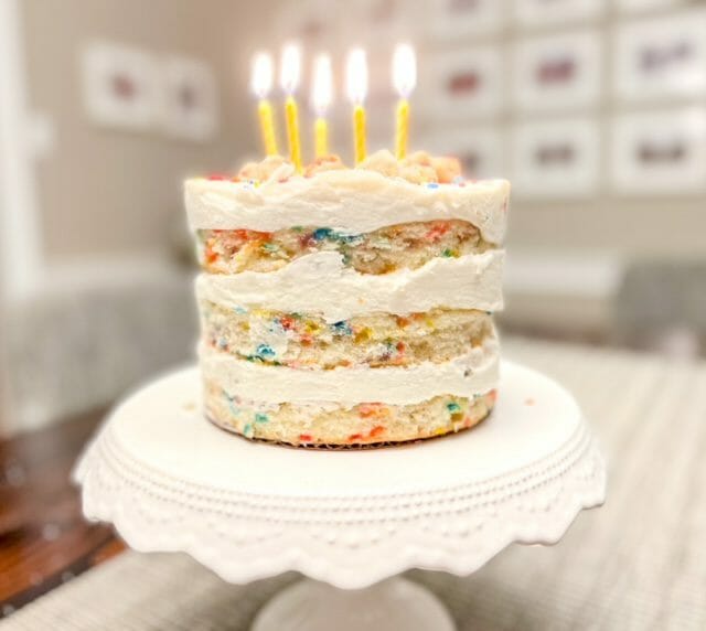 milk bar vanilla birthday cake with lit candles-milk bar birthday cake review-mealfinds