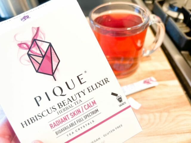 hibiscus beauty elixir box and glass of tea-pique tea crystal reviews-mealfinds
